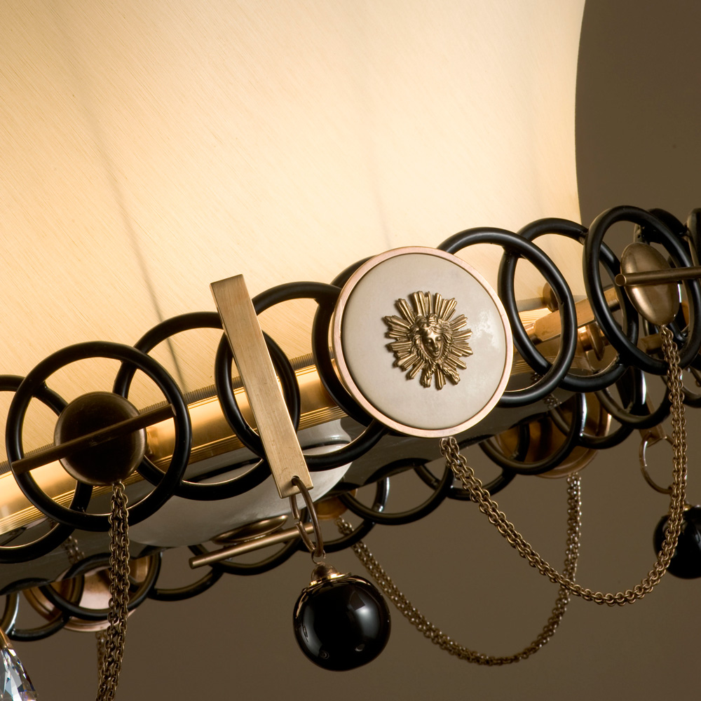 Chandelier in black glazed and burnished bronze. Hand glazed majolica details and crystal pendants. Ivory “Lebock” silk double lampshade.